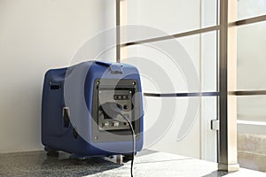 Modern portable power station on floor indoors