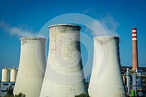 Modern power station cooling towers against a blue sky
