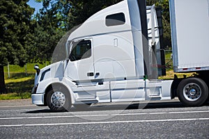 Modern powerful leader semi truck profile white nice road