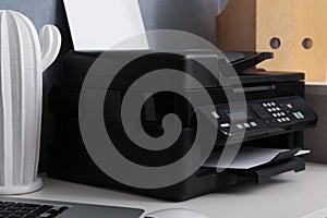 Modern printer and decor element on white table