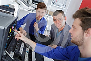 modern printing machine operator and apprentice