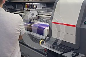 Modern printing machine and worker near it