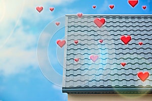 Modern private house on background of blue sky with red hearts. Love home, insurance and mortgage, property real estate investment