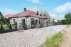 Modern private house with metal fence. Building process in town suburbs.