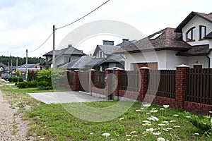 Modern private house with metal fence. Fence and the modern house