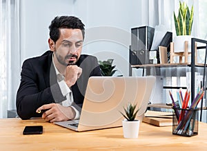 Modern professional businessman at modern office desk. fervent