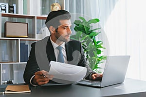 Modern professional businessman at modern office desk. fervent