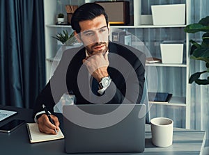 Modern professional businessman at modern office desk. fervent