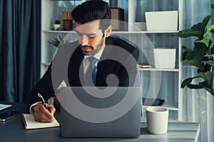 Modern professional businessman at modern office desk. fervent