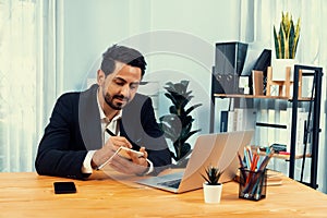 Modern professional businessman at modern office desk. fervent