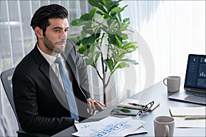 Modern professional businessman at modern office desk. fervent