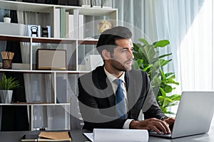 Modern professional businessman at modern office desk. fervent