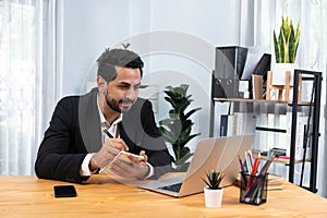 Modern professional businessman at modern office desk. fervent