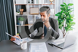 Modern professional businessman at modern office desk. fervent