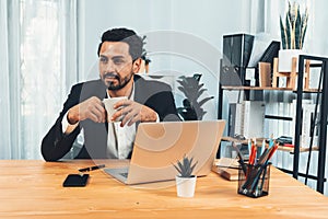 Modern professional businessman at modern office desk. fervent