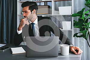 Modern professional businessman at modern office desk. fervent