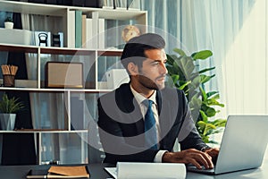 Modern professional businessman at modern office desk. fervent