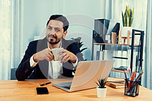 Modern professional businessman at modern office desk. fervent