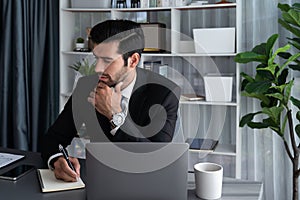 Modern professional businessman at modern office desk. fervent