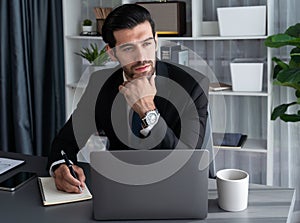 Modern professional businessman at modern office desk. fervent