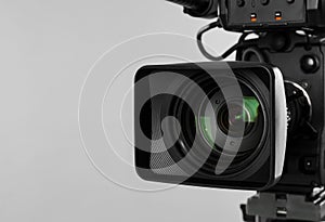 Modern professional video camera on background, closeup