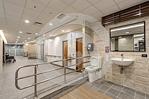 Public disabled restroom with handrails and accessibility features photo