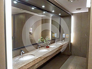 Modern Public Restroom with Marble Sinks and Large Mirror