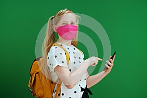 Modern pupil using phone applications against green background