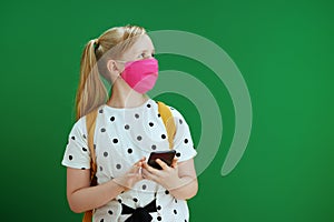 Modern pupil using phone applications against green background