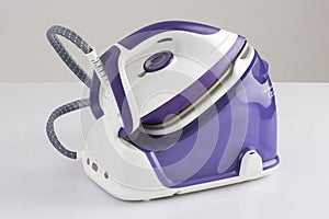 Modern purple steam iron  on white