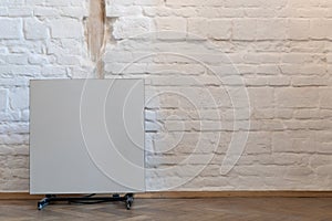 Modern radiator near white wall in room