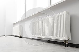 Modern radiators in room. Central heating system photo