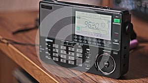 Modern Radio with Digital LCD Scale Scanning FM Frequency on the Table