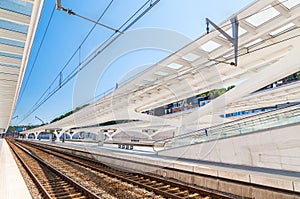 Modern railway station with transparent ceiling and blue sky
