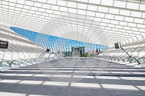 Modern railway station with transparent ceiling and blue sky