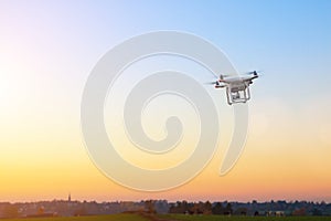 Modern RC UAV Drone / Quadcopter with camera flying on a clear s photo