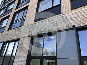 Modern real estate, residential apartment building, entrance with glass canopy door