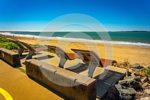 Modern reclined beach chairs along the sandy beach