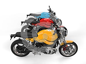 Modern red, blue and yellow chopper motorcycles - top down side view