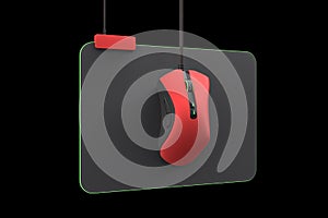 Modern red gaming mouse on professional pad isolated on black with clipping path