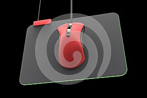 Modern red gaming mouse on professional pad isolated on black with clipping path