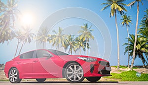 Modern red luxury car with palm trees in the background