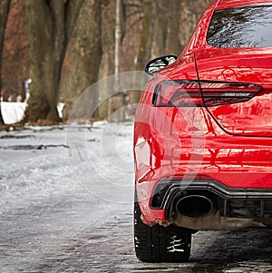 Modern red sport car in the winter forest background,  car wallpaper