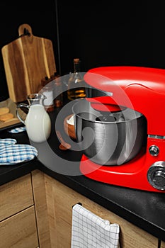 Modern red stand mixer and ingredients on countertop in kitchen