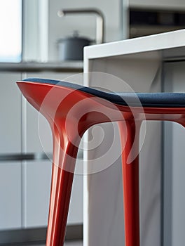 Modern red stool in a contemporary kitchen setting.