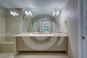 Modern refreshing bathroom with a beige dual washstand.