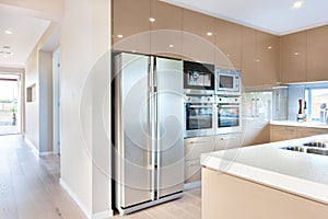 Modern refrigerator in the luxury kitchen with microwave ovens,