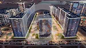 Modern residential area with parked cars at night aerial view