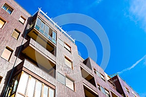 Modern residential building with tiled facade in a sunny day, Italy