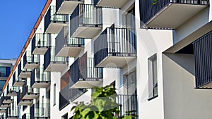 A modern residential building in the vicinity of trees.